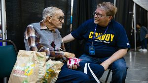 Volunteer talking to elderly man