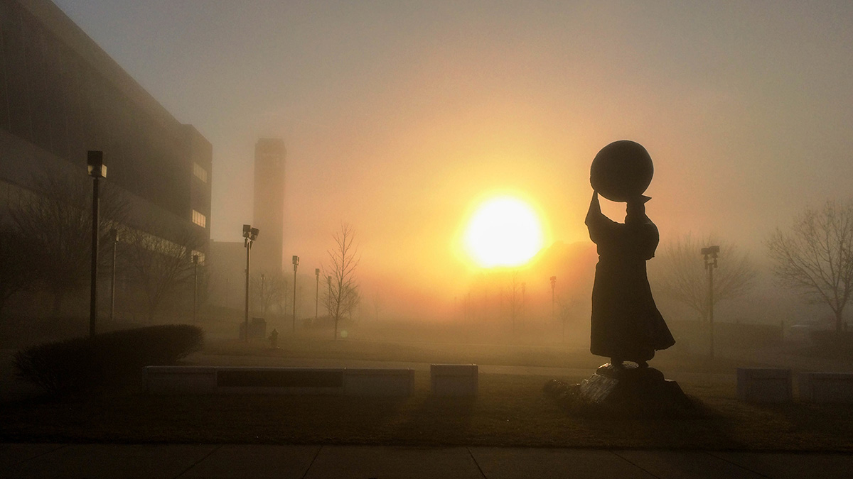 The Public Affairs statue on campus in early morning sun.
