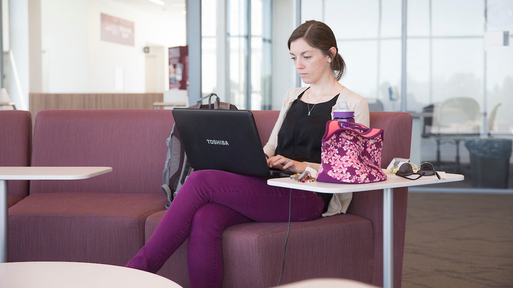 A student types on her laptop.