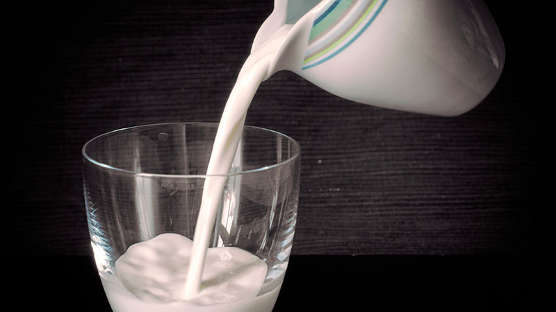 Pouring milk into a glass.