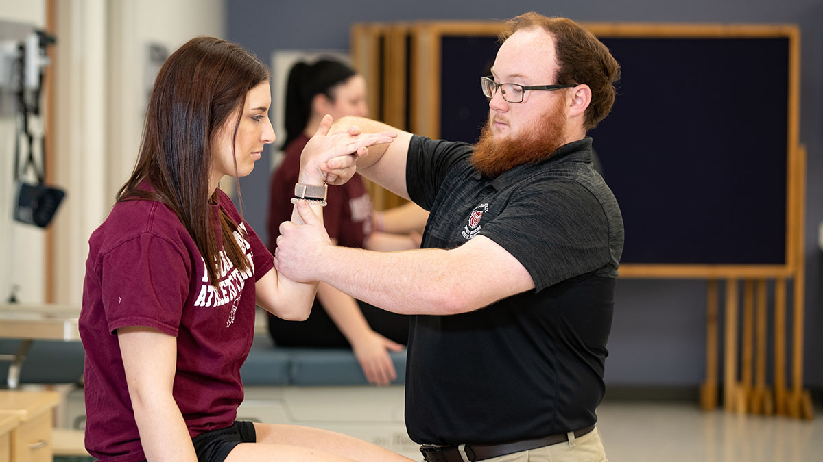 Athletic training students practice in class