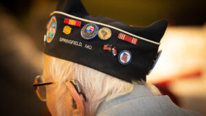 Man wearing hat with military pins.