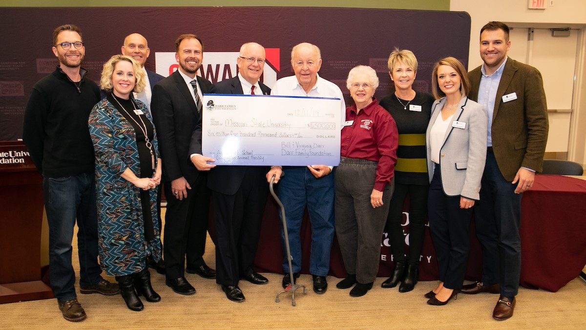 The Darr family presents a check to Missouri State.
