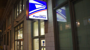 A United States Post Office sign by the entrance