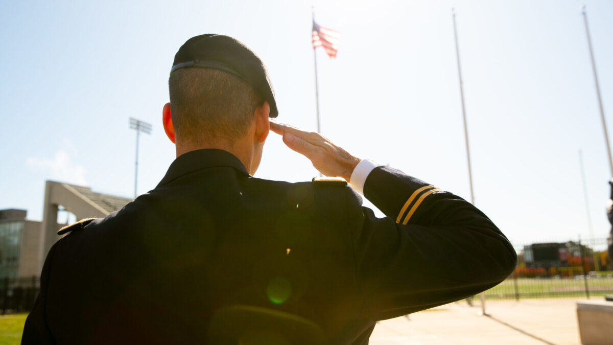 A veteran salutes the American flag on Missouri State's campus.