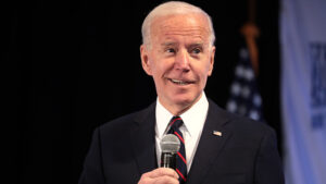 President-elect Joe Biden holds a microphone.