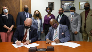 Missouri State President Clif Smart and SAAB CEO Dr. Tyrone Bledsoe sign the scholarships agreement.