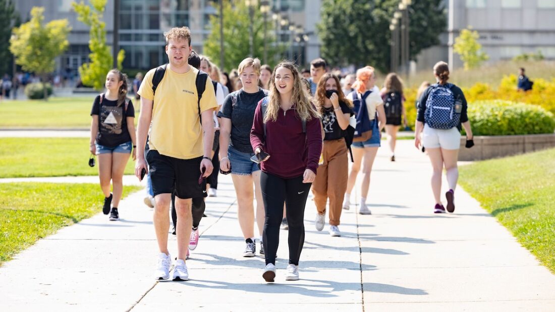 Students walk to their next classes on a sunny September day.