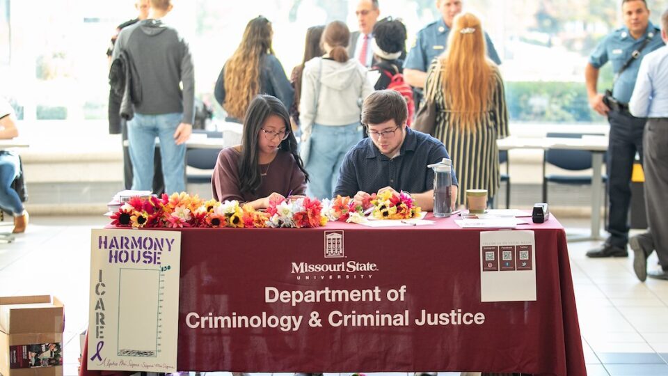 Criminology students host a table during a departmental open house in 2019.