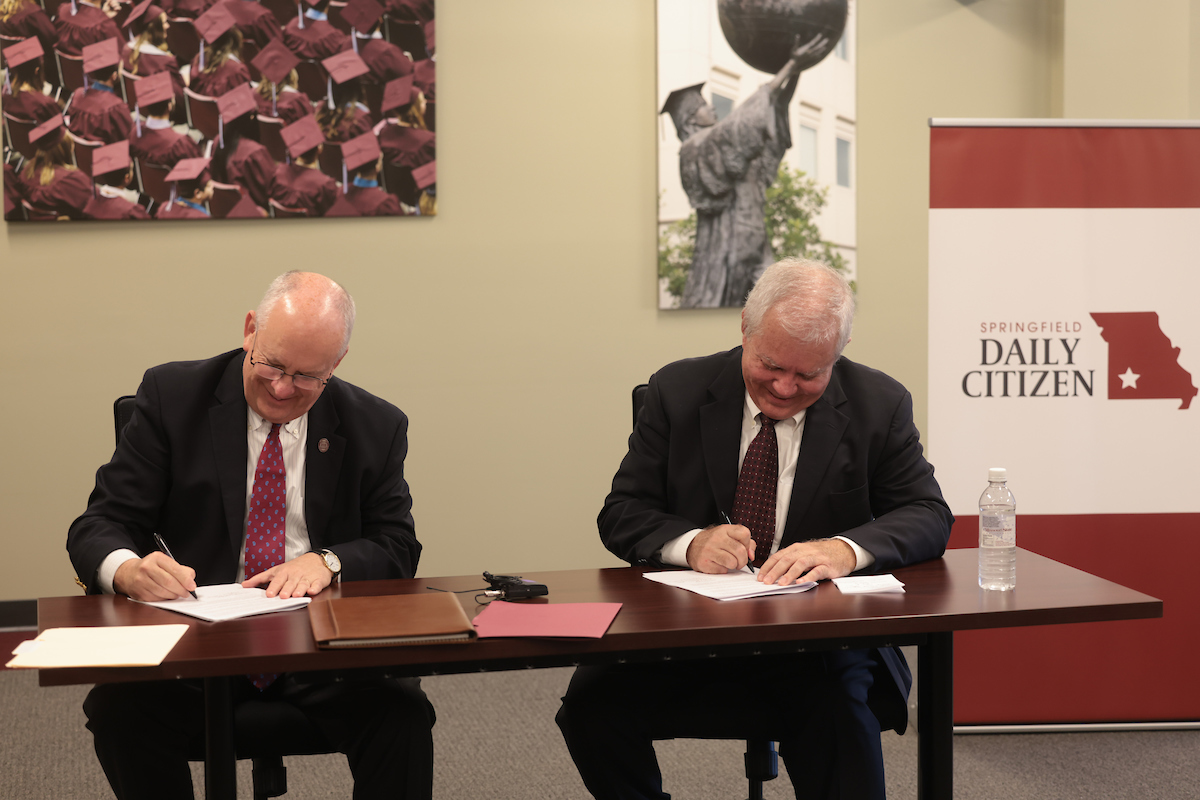 Clif Smart and Tom Carlson sign the MOU.