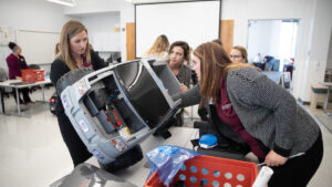 Occupational Therapy students work on adapted car for the GoBabyGo eevnt