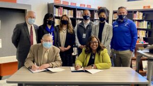 Administrators from Missouri State and Springfield Public Schools sign a memorandum of understanding.