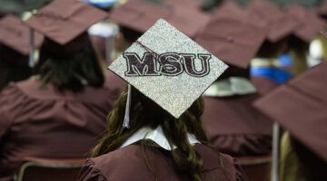 A graduate's mortarboard with "MSU" on it.