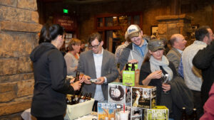 Patrons visit craft beer vendor table at most recent Wine and Food Celebration.