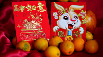 Lunar New Year red packets and oranges.