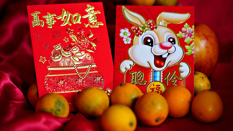 Lunar New Year red packets and oranges.