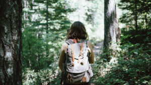 A girl hiking with an adventure backpack.