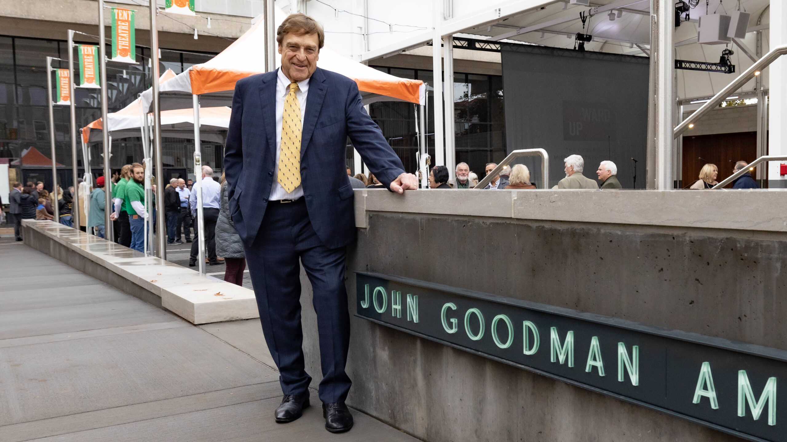 John Goodman stands in front of a sign for his Amphitheatre on the Missouri State campus.