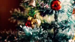 A close up photo of a Christmas tree and ornaments.