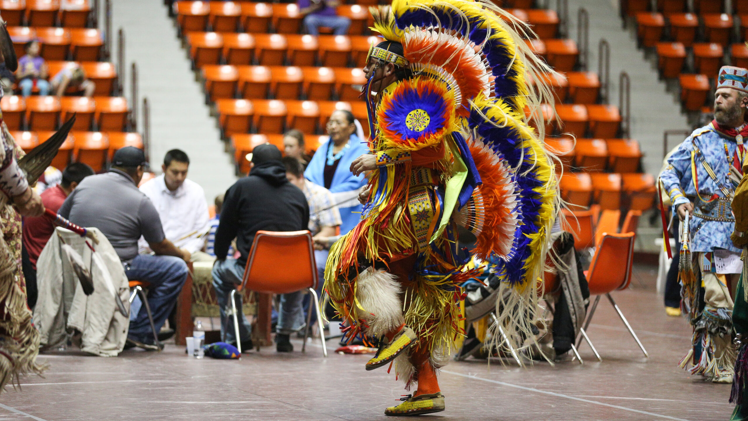 A dancer is full traditional dress during a Native American Heritage Month powwow in Hammons Student Center.