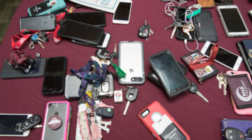 cell phones and keys lay on a table