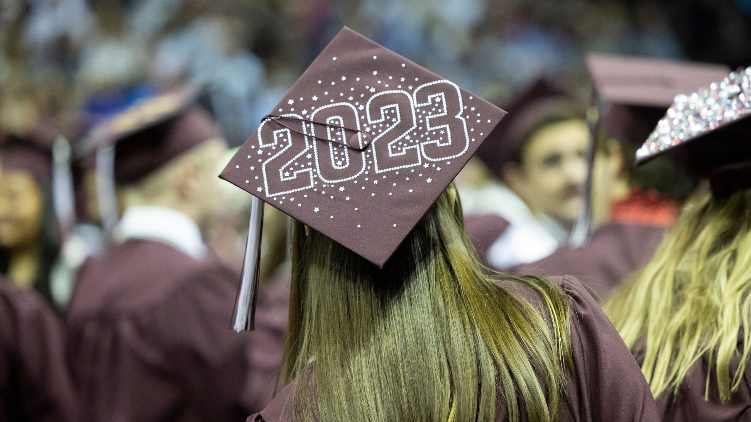 A graduation hat bejeweled with the year 2023