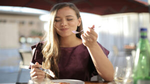 A woman savoring a plate of food.