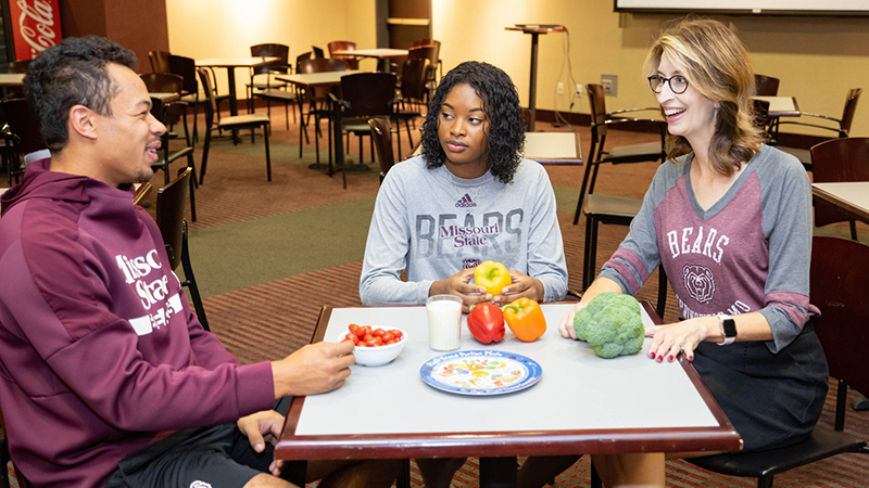 Registered dietitian Natalie Allen (right) talks about food with students.