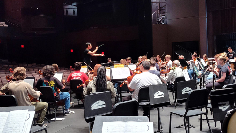 Dr. Yi-Ping Chen, Missouri State University orchestra director and assistant professor of music, leads the Missouri State Symphony Orchestra during a practice.