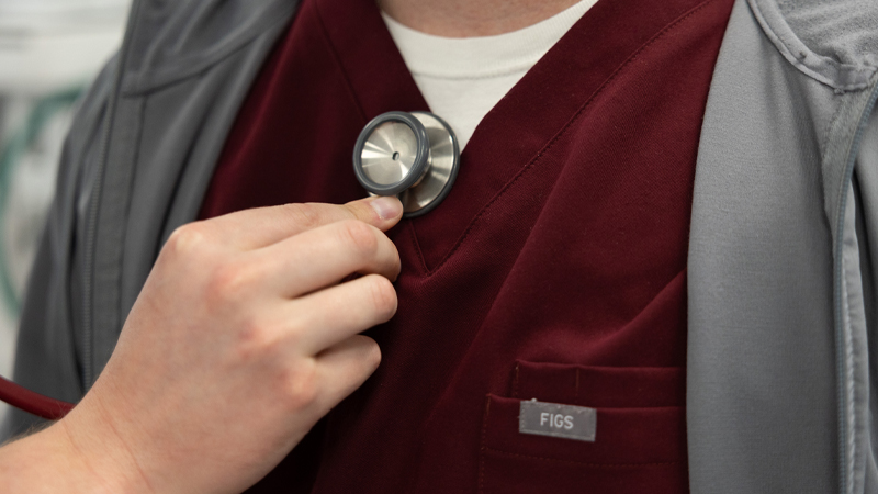A Missouri State student holds a stethoscope to another student's chest
