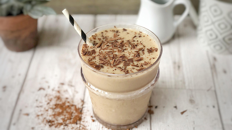 A glass of milkshake with protein powder.