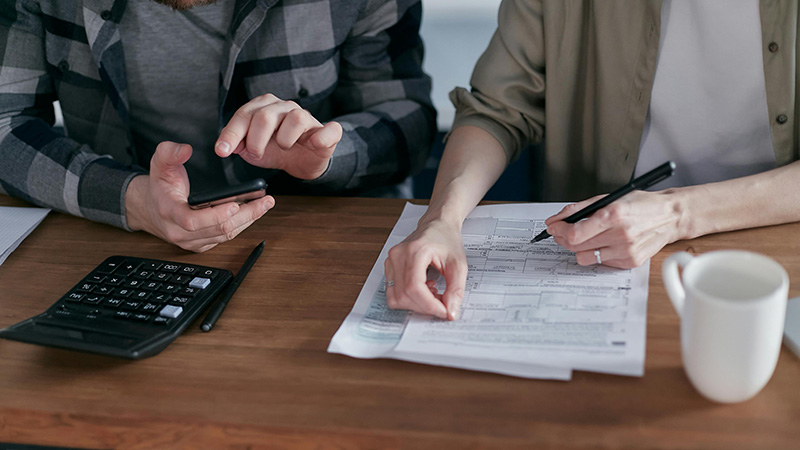 A couple work on income tax return.