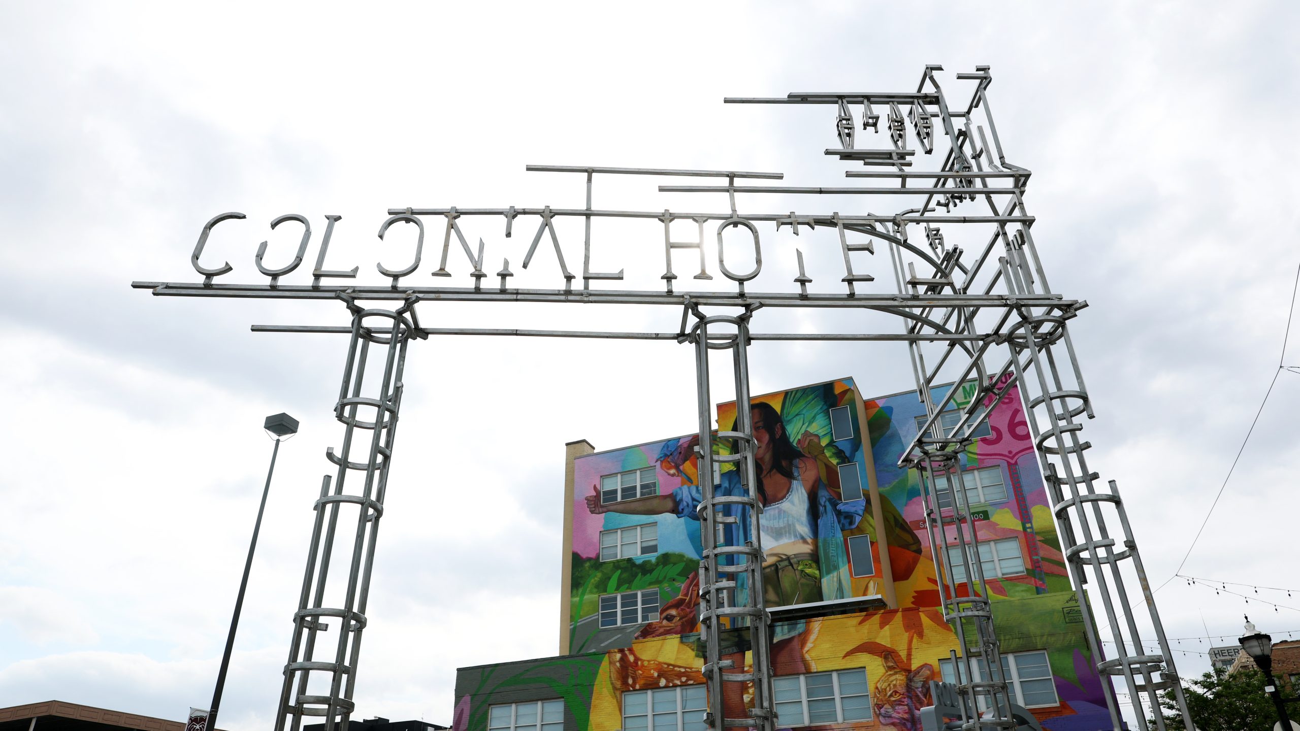 The Colonial Hotel sculpture takes shape with a colorful mural int he background.