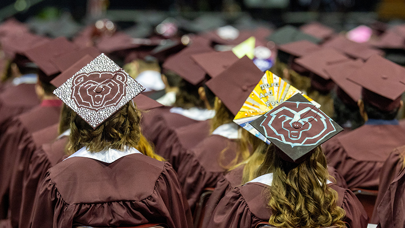 A group of Missouri State University students at a commencement ceremony.