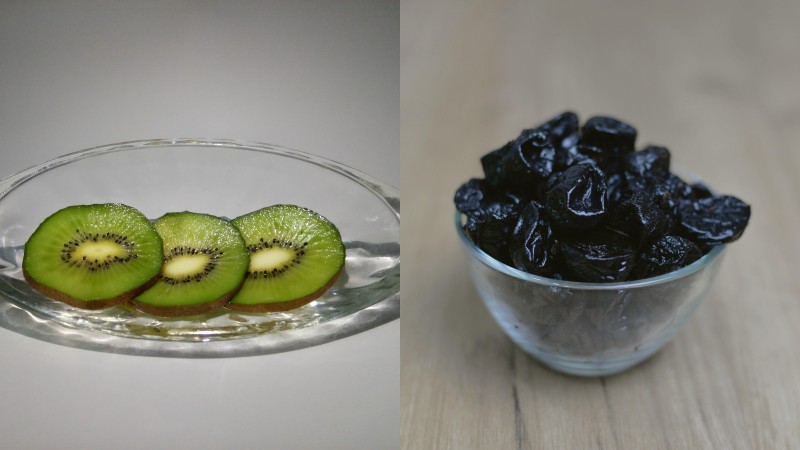 Cut kiwi on a glass plate and prunes in a blass bowl.