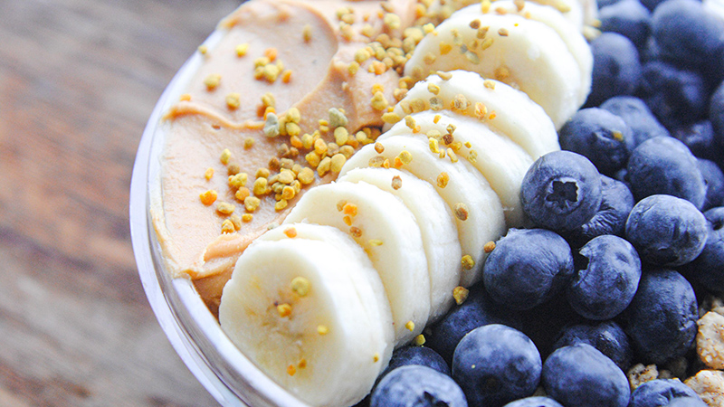 An acai bowl with bananas and blueberries.