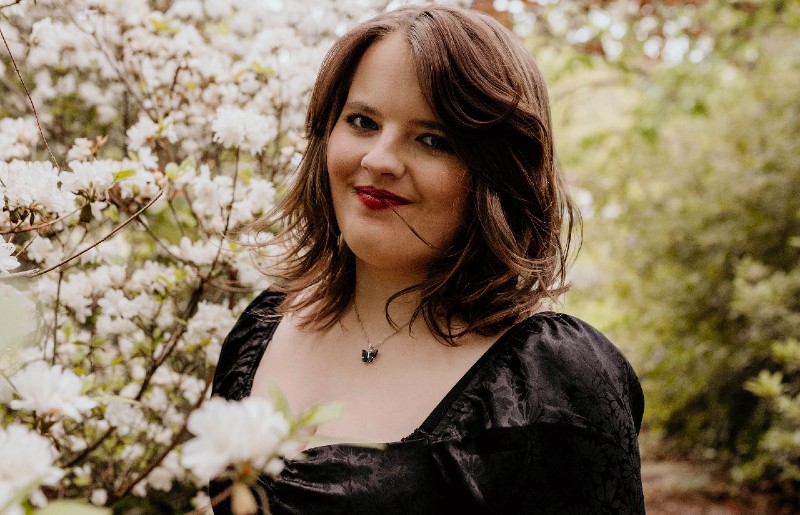 Abigail Hardwick surrounded by flowers.